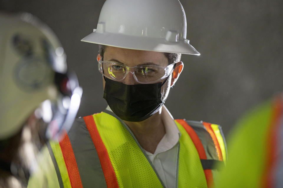 U.S. Secretary of Transportation Pete Buttigieg receives a tour of an underground tunnel for the expansion of the Hartsfield–Jackson Atlanta International Airport plane train tunnel at the Hartsfield–Jackson Atlanta International Airport, Friday, May 21, 2021, in Atlanta. (Alyssa Pointer/Atlanta Journal-Constitution via AP)