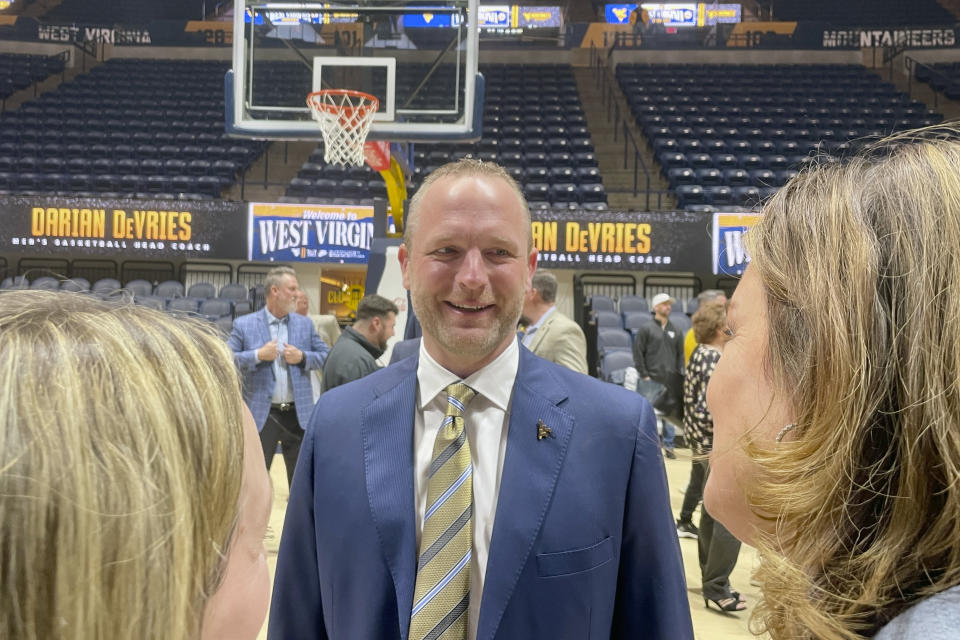 New West Virginia men's NCAA college basketball coach Darian DeVries talks with fans after an introductory news conference Thursday, March 28, 2024, in Morgantown, W.Va. (AP Photo/John Raby)