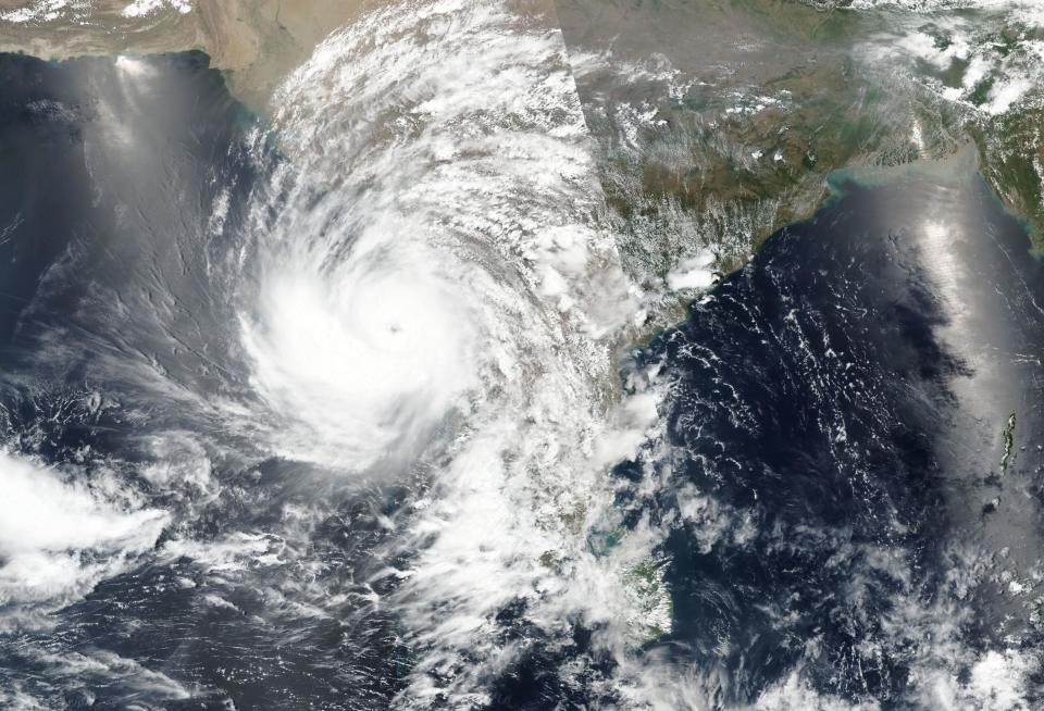 This Sunday, May 16, 2021, satellite image released NASA shows a cyclone approaching western India. A severe cyclone is roaring in the Arabian Sea off southwestern India with winds of up to 140 kph (87 mph), already causing heavy rains and flooding that have killed multiple people, officials said Sunday. Cyclone Tauktae, the season’s first major storm, is expected to make landfall early Tuesday in Gujarat state, a statement by the India Meteorological Department said. (NASA Worldview, Earth Observing System Data and Information System (EOSDIS) via AP)