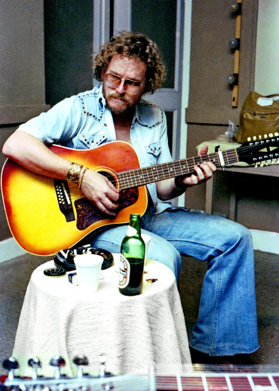 Gordon Lightfoot has a beer handy as he practices in the 1970s. Monroe musician Tom Treece witnessed Lightfoot record his hit song "The Wreck of the Edmund Fitzgerald" in a Toronto music studio.