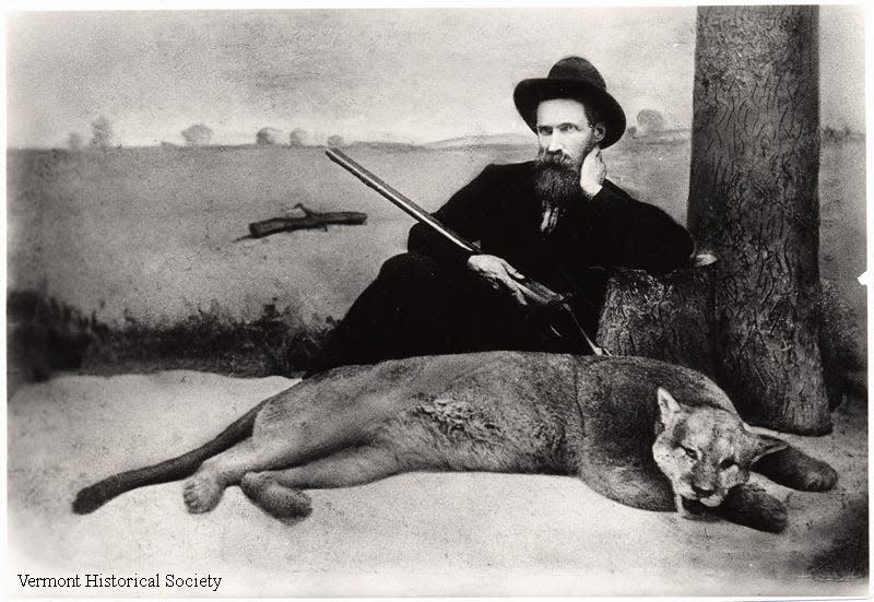 Alexander Crowell poses with a catamount, or mountain lion, that he shot and killed in November 1881. It proved to be the last sighting of the species in Vermont.