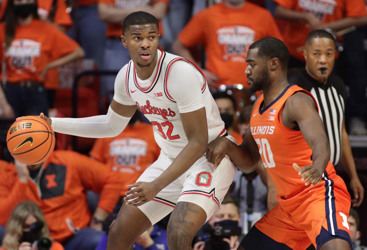 Feb 24, 2022; Champaign, Illinois, USA;  Ohio State Buckeyes forward E.J. Liddell (32) controls the ball against Illinois Fighting Illini guard Da'Monte Williams (20) during the first half at State Farm Center. Mandatory Credit: Ron Johnson-USA TODAY Sports