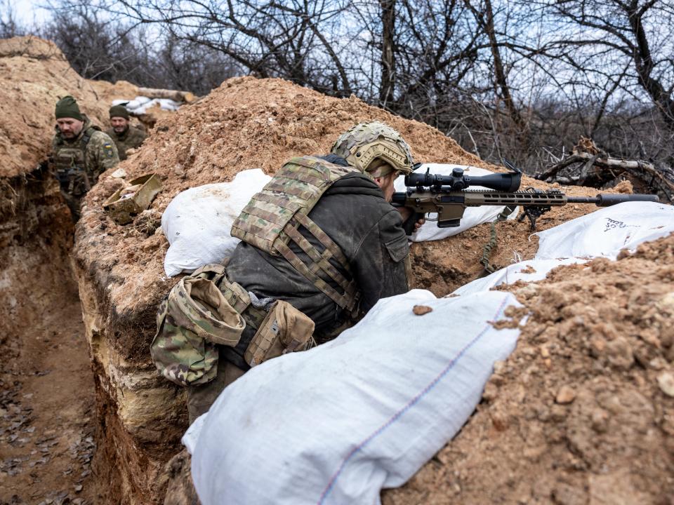 A Ukrainian sniper with the 28th Brigade looks towards a Russian position from a frontline trench on March 05, 2023 outside of Bakhmut, Ukraine.