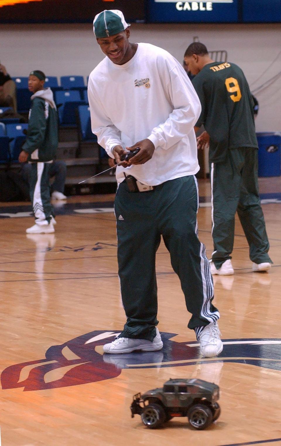 LeBron James plays with a remote-controlled Hummer before St. Vincent-St. Mary's game against Mentor on Jan. 14, 2003, at the University of Akron's Rhodes Arena.