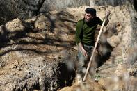 <p>A fighter from the Free Syrian Army’s Al Majd Brigades digs a trench in the rebel held besieged area of al-Marj in the Eastern Ghouta of Damascus, Syria Feb. 18, 2017. (Photo: Bassam Khabieh/Reuters) </p>