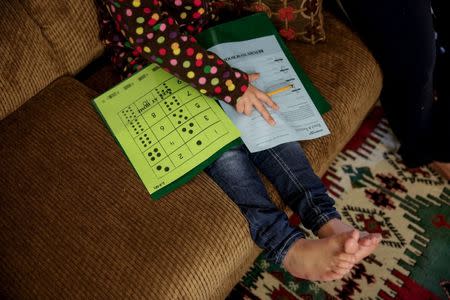 Five-year-old Syrian refugee Leen works on her homework at her new home in Sacramento, California, November 16, 2015. REUTERS/Max Whittaker