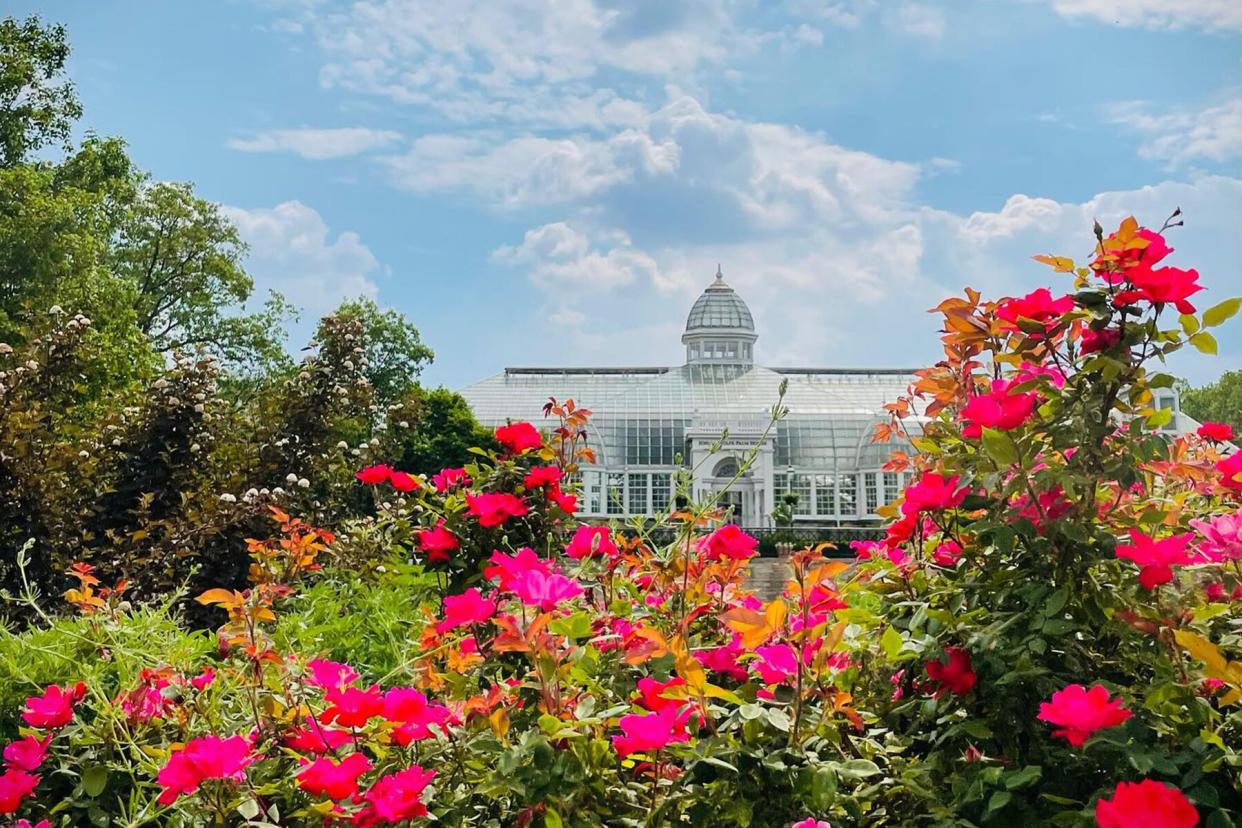 The Palm House surrounded by flowers at Franklin Park Conservatory and Botanical Gardens, Ohio