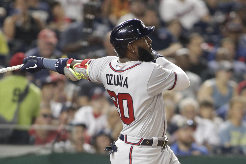 Atlanta Braves' Marcell Ozuna follows through on two-run home run during the third inning of a baseball game against the Washington Nationals, Monday, June 13, 2022, in Washington. (AP Photo/Luis M. Alvarez)