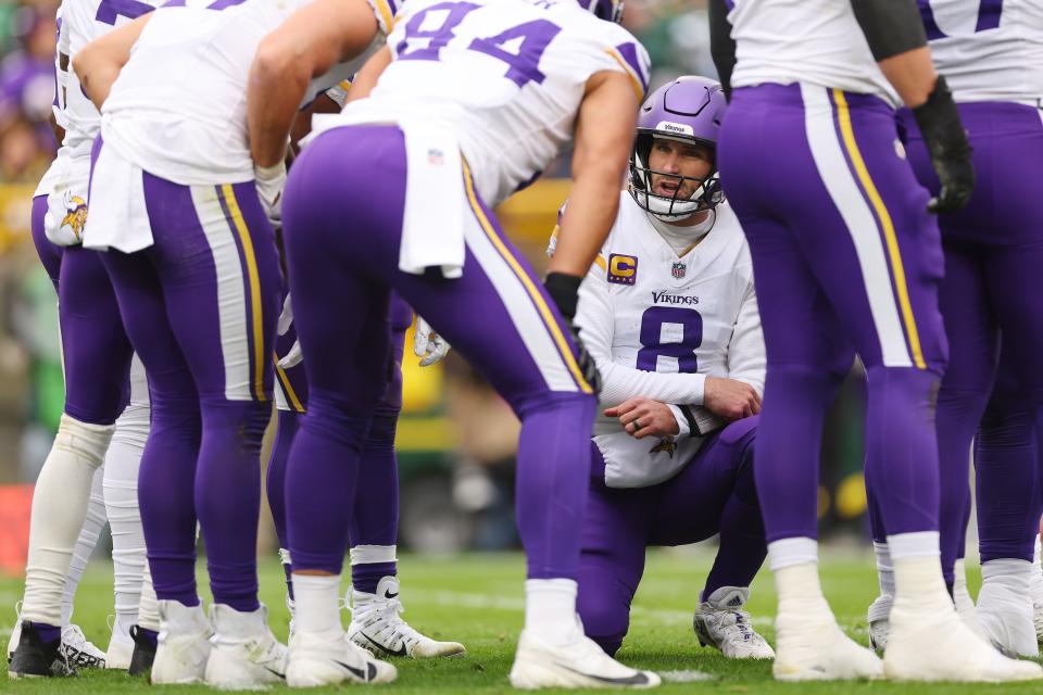 GREEN BAY, WISCONSIN - OCTOBER 29: Kirk Cousins #8 of the Minnesota Vikings huddles with the offense against the Green Bay Packers at Lambeau Field on October 29, 2023 in Green Bay, Wisconsin. (Photo by Michael Reaves/Getty Images)