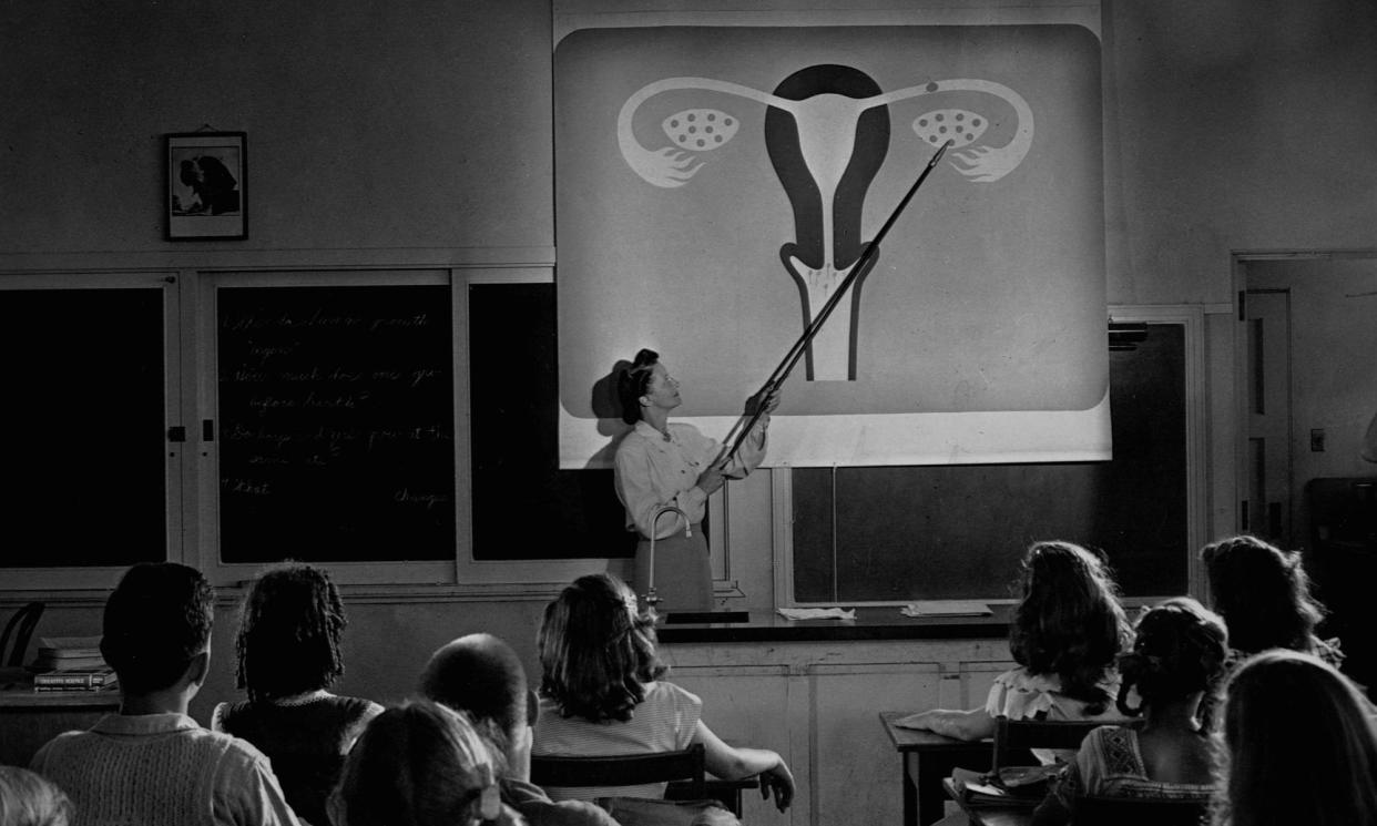 <span>A teacher points to a diagram of female reproductive organs projected on a screen in a classroom in a scene from Human Growth, an education film on sex education shown to students in Oregon junior high schools from 1948.</span><span>Photograph: Library of Congress/Corbis/VCG/Getty Images</span>