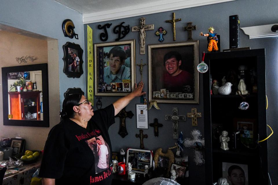 Leticia de la Rosa points to old images of her son James inside of her Bakersfield home.