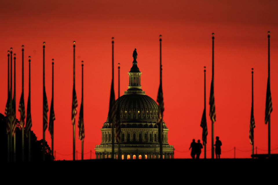 The U.S. Capitol dome is the backdrop for flags lowered to half-staff in honor of the victims killed in the Las Vegas shooting as the sun rises on Oct. 3, 2017, at the foot of the Washington Monument on the National Mall in Washington. (Photo: Manuel Balce Ceneta/AP)