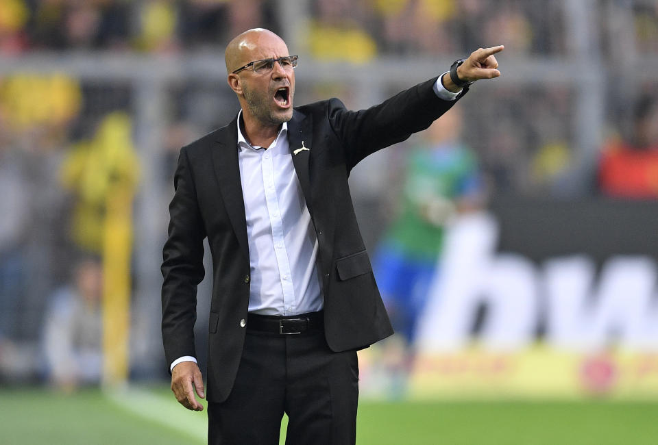 FILE - In this Saturday, Aug. 26, 2017 file photo Dortmund's then coach Peter Bosz reacts during the German Bundesliga soccer match between Borussia Dortmund and Hertha BSC Berlin in Dortmund, Germany. German Bundesliga soccer club Bayer 04 Leverkusen has introduced Bosz as the new headcoch and successor of coach Heiko Herrlich who was dismissed on Sunday. (AP Photo/Martin Meissner, file)