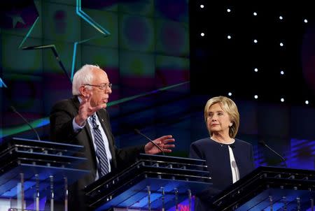 Democratic presidential candidate Senator Bernie Sanders speaks as former Secretary of State Hillary Clinton looks on during the first official Democratic candidates debate of the 2016 presidential campaign in Las Vegas, Nevada October 13, 2015. REUTERS/Lucy Nicholson