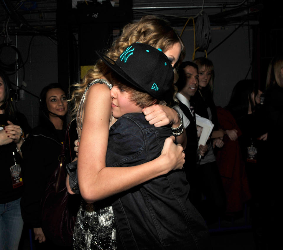 Taylor Swift and Justin Bieber embrace at Z100's Jingle Ball in 2009. (Kevin Mazur/WireImage for Clear Channel Radio New York)
