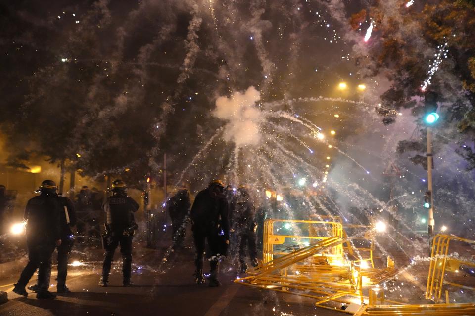 Police forces clash with youths in Nanterre, outside Paris, Thursday, June 29, 2023. The death of 17-year-old Nahel by police during a traffic check Tuesday in the Paris suburb of Nanterre elicited nationwide concern and widespread messages of indignation and condolences. Interior Minister Gerald Darmanin said 1,200 police were deployed overnight and 2,000 would be out in force Wednesday in the Paris region and around other big cities to "maintain order." (AP Photo/Christophe Ena)