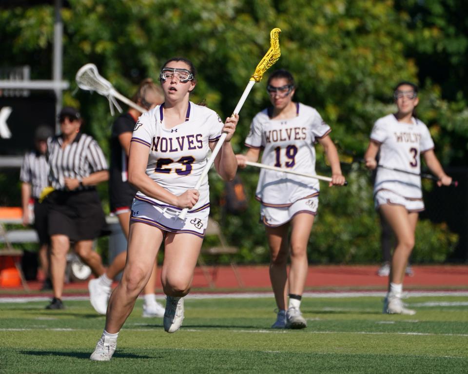 John Jay-Cross River's Jane Brennan (23) looks to set up a play during their 10-8 win over Rye in the girls lacrosse Section 1 Class C championship game at Nyack High School in Nyack on Friday, May 26, 2023.