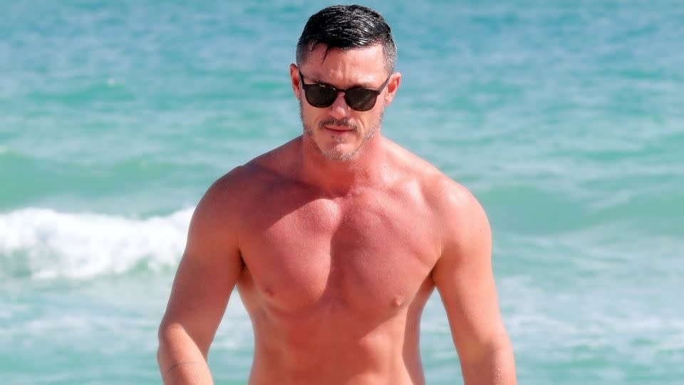 Welsh actor Luke Evans wears swimming briefs on the beach in Miami in 2020. - SBCH/Backgrid