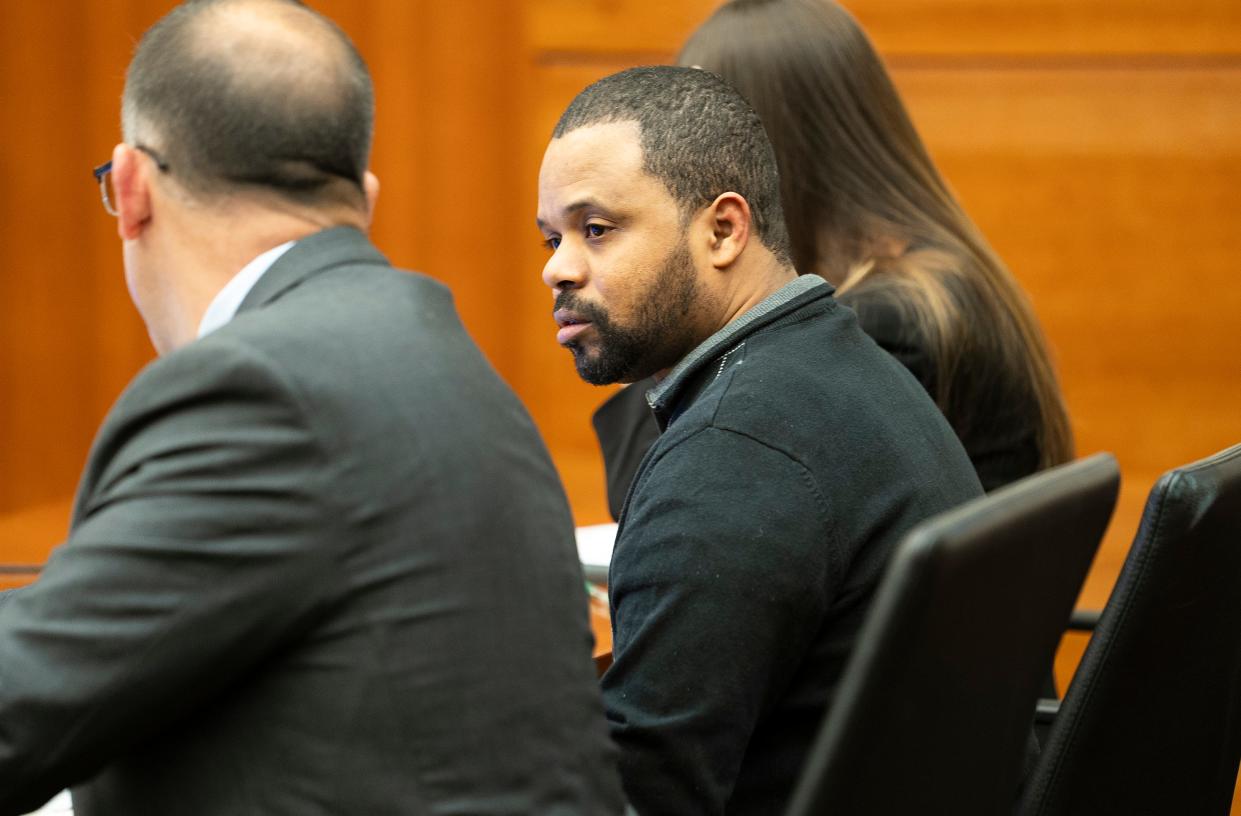 John W. Wooden, center, sits between his defense attorneys, Paul Scarsella and Olivia Rancour, for the start of his murder trial on Monday, Oct. 16, 2023, in Franklin County Common Pleas Court. Wooden is accused of kidnapping and murdering prominent local Imam Mohamed Hassan Adam in December 2021.