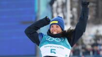 <p>Charlotte Kalla of Sweden celebrates winning the first gold medal of the Games in the women's skiathlon.</p>