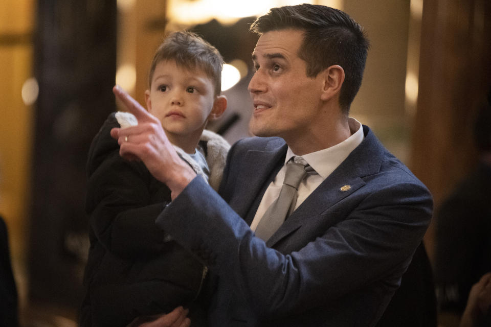 FILE - Nebraska state Sen. John Fredrickson shows his son, Leon, the inside of the west wing on the first day of the 2023 state Legislature, Jan. 4, 2023, at the state Capitol in Lincoln, Neb. Nebraska could join 48 other states in offering public money for private school tuition under a bill advanced by the state Legislature on Wednesday, March 8, 2023, even as some lawmakers expressed concern about taxpayer dollars going to private schools allowed to turn away students based on religious tenets. (Kenneth Ferriera/Lincoln Journal Star via AP, File)