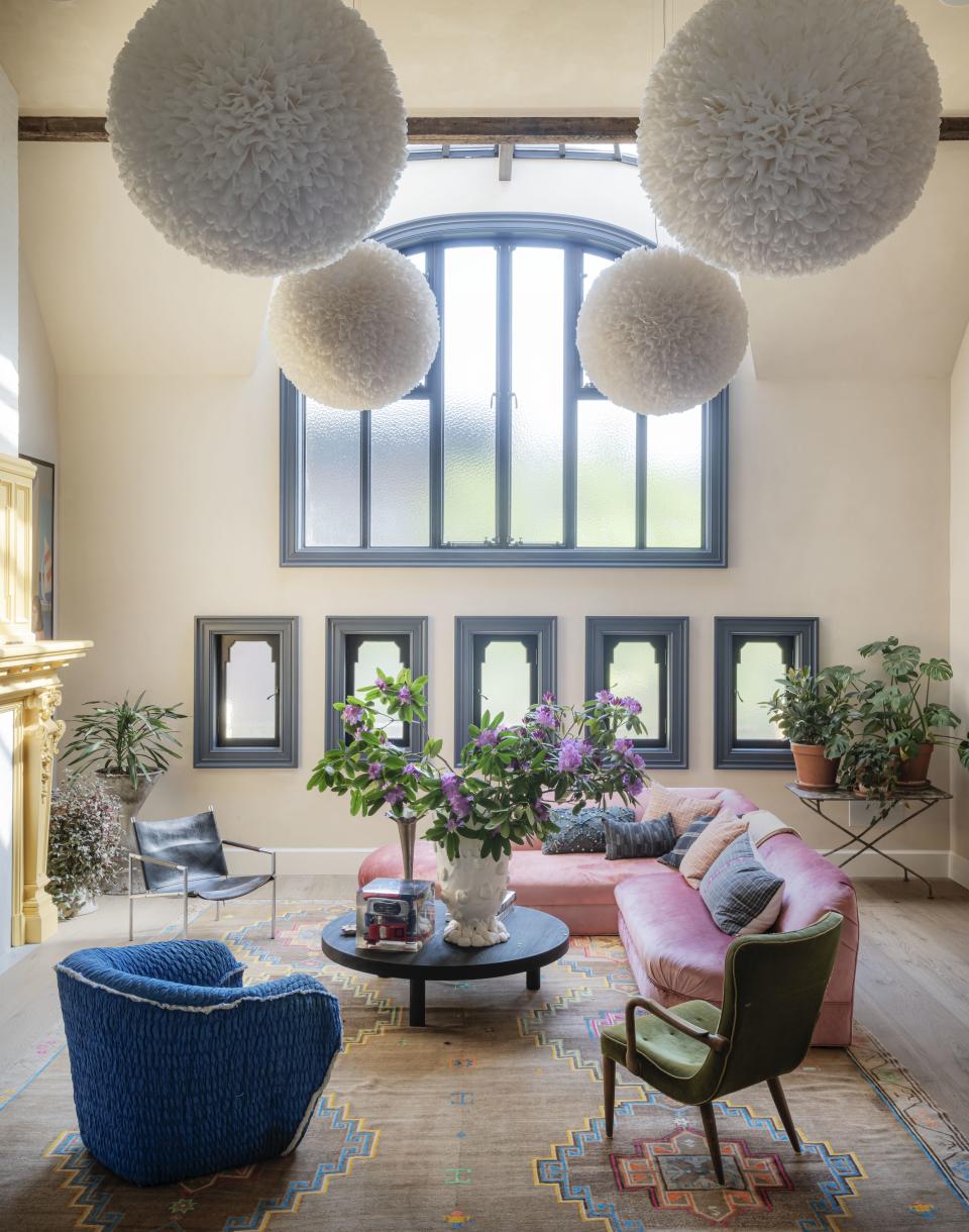 A ball room with hanging lights and pink walls