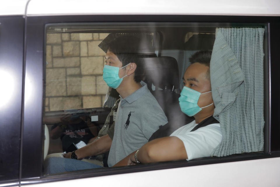 Pro-democracy legislator Ted Hui, center, is arrested by police officers in Hong Kong, Wednesday, Aug. 26, 2020. Hong Kong police arrested 16 people Wednesday on charges related to anti-government protests last year, including two opposition lawmakers. Pro-democracy legislators Ted Hui and Lam Cheuk-ting were arrested early Wednesday, according to posts on their Facebook pages. (AP Photo/Kin Cheung)