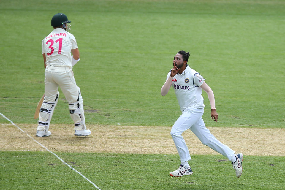 Mohammed Siraj of India celebrates after taking the wicket of David Warner of Australia during day one of the 3rd Test match in the series.