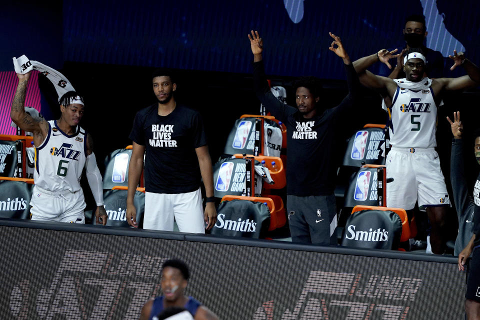 The Utah Jazz bench cheers during the first half of an NBA basketball game against the Dallas Mavericks Monday, Aug. 10, 2020, in Lake Buena Vista, Fla. (AP Photo/Ashley Landis, Pool)