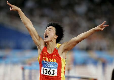 China's Liu Xiang celebrates as he crosses the finish line to win the men's 110 metres hurdle final at the Athens 2004 Olympic Summer Games in this August 27, 2004 file photo. REUTERS/Gary Hershorn