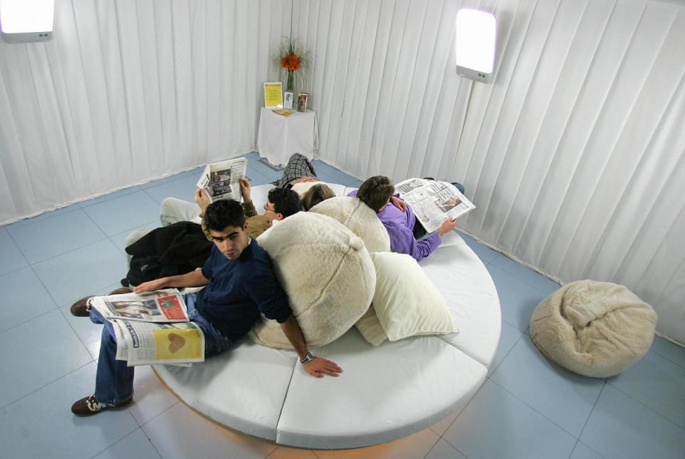 Visitors sit in the new Light Lounge, an ambient white space containing four specially designed light boxes where visitors can relax and have light therapy, in the Science Museum's Dana Centre in London (JOHN D MCHUGH/AFP/Getty Images)