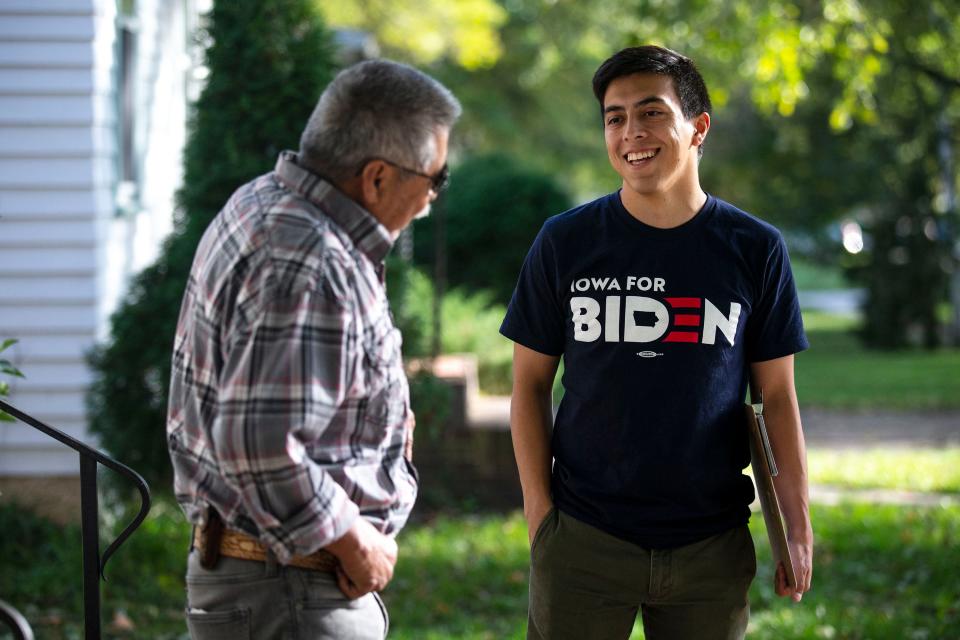 Camilo Haller, a field organizer for Joe Biden's campaign for president, talks to Ramon Medina-Rios, of Storm Lake, while knocking doors on Thursday afternoon, Oct. 17, 2019, in Storm Lake.  