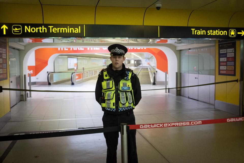 A police officers stands in front of an area of Gatwick Airport's North Terminal which has been cordoned off, as a 41-year-old man from France is being questioned by police after &quot;what appears to be a firearm&quot; was discovered at the airport, Sussex Police said.