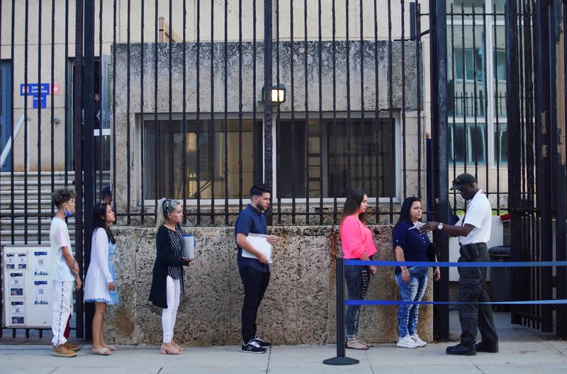 People wait in line to enter the U.S. embassy in Havana
