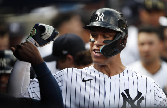 New York Yankees right fielder Aaron Judge (99) celebrates in the dugout after hitting a home run against the Minnesota Twins during the sixth inning of a baseball game Monday, Sept. 5, 2022, in New York. (AP Photo/Noah K. Murray)