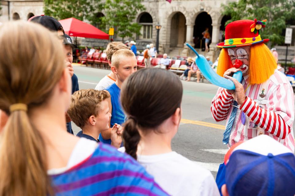 A clown blows up a balloon before the start of the annual Days of ’47 Parade in Salt Lake City on Monday, July 24, 2023. | Megan Nielsen, Deseret News