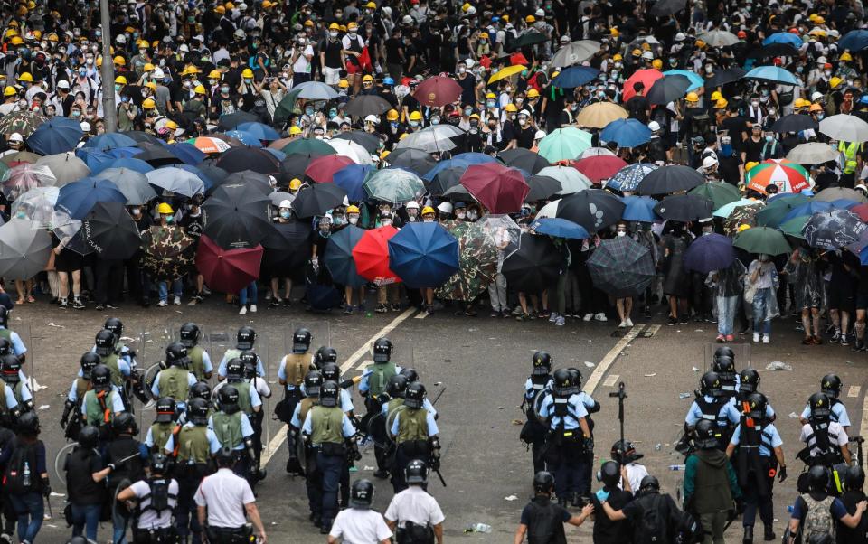 Protesters face off with police outside the government headquarters in Hong Kong on June 12 2019