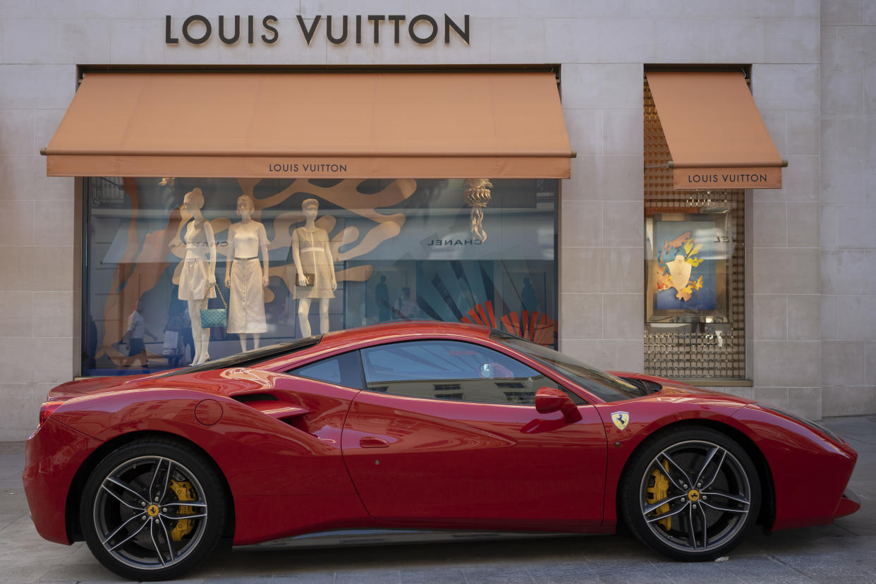 A red Ferrari is parked on the pavement outside the Louis Vuitton store in Bond Street, on 12th August 2022, in London, England. After the Bank of England raised interest rates to 1.75%, there is a certainty that Britain will be in recession by the fourth quarter of 2022 and with inflation to climb further. (Photo by Richard Baker / In Pictures via Getty Images)