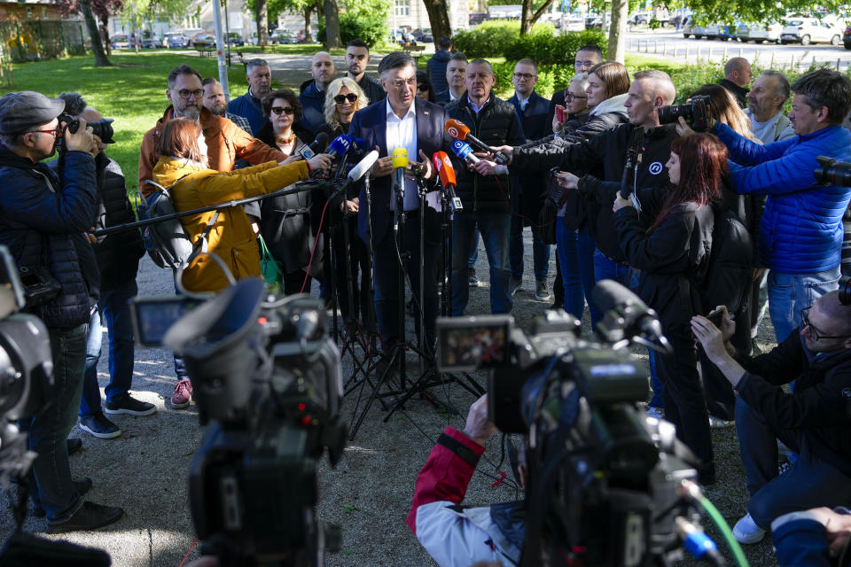 Prime Minister incumbent Andrej Plenkovic speaks to the media after casting his ballot at a polling station in Zagreb, Croatia, Wednesday, April 17, 2024. Croatia is voting in a parliamentary election after a campaign that centered on a bitter rivalry between the president and prime minister of the small European Union and NATO member. (AP Photo/Darko Vojinovic)