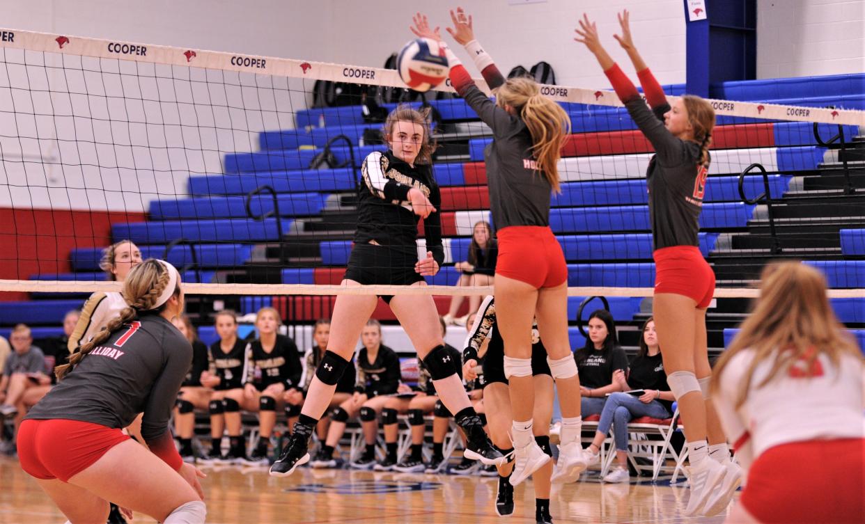 Bushland's Madyson Eberly watches her shot sail past a pair of Holliday defenders. Bushland won 25-19, 25-20 to win the Bev Ball Classic last season at Cougar Gym. Bushland didn't return this season, but Holliday is back.