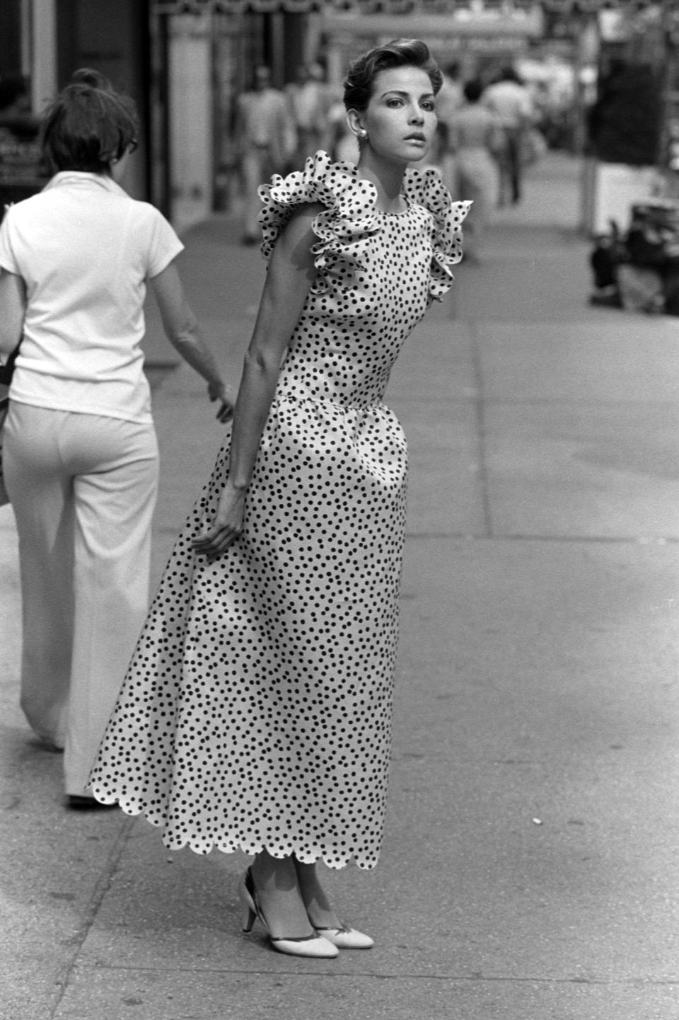 A model poses in a scalloped polka-dot dress from Carolina Herrera's 1983 Resort collection advance.