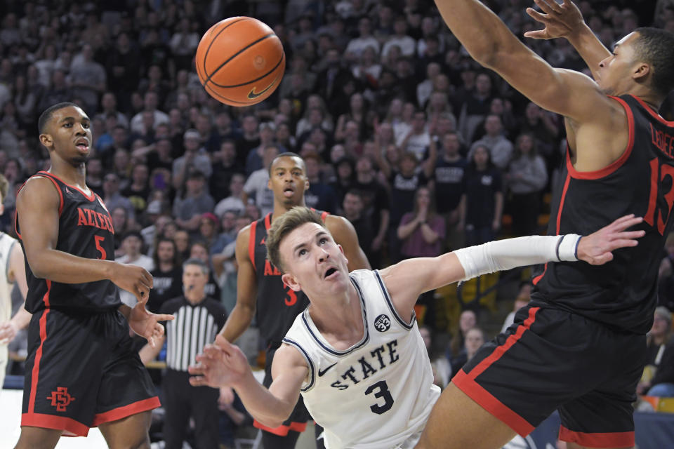Utah State guard Steven Ashworth (3) is fouled by San Diego State forward Jaedon LeDee (13) during the second half of an NCAA college basketball game Wednesday, Feb. 8, 2023, in Logan, Utah. (AP Photo/Eli Lucero)