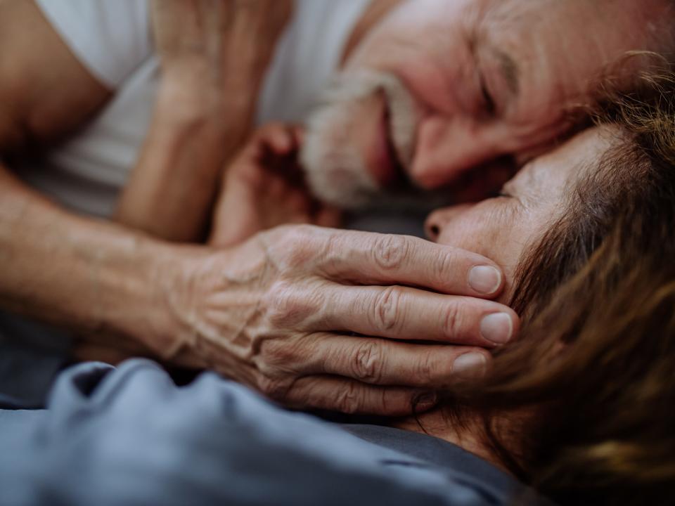 Old couple cuddling.