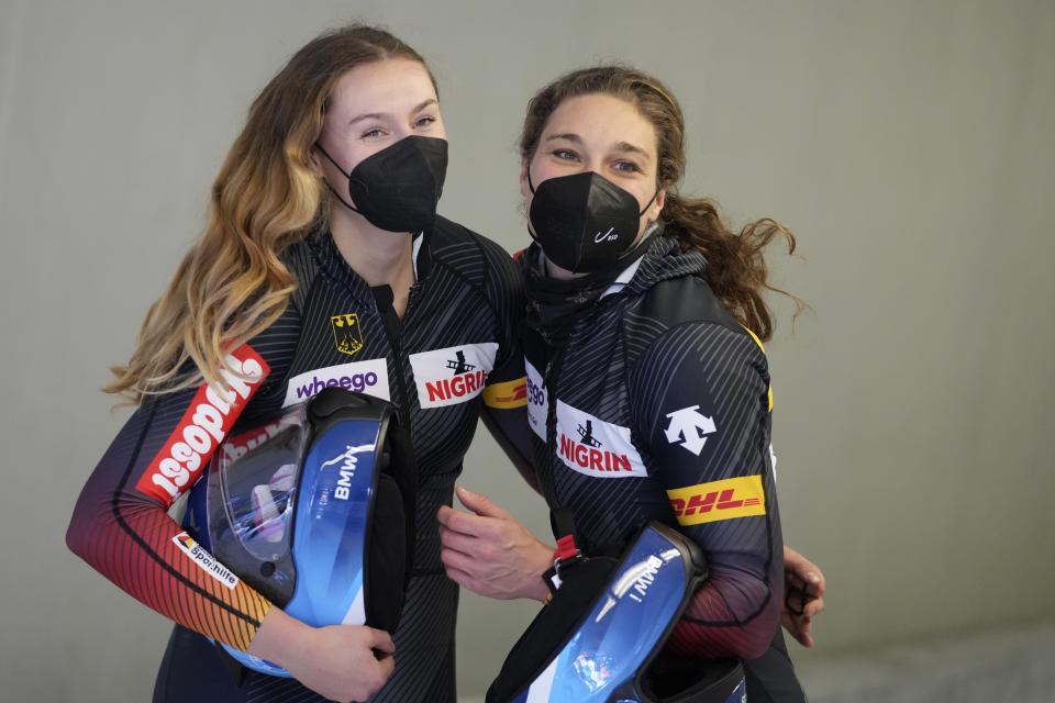 Laura Nolte, left, and Leonie Fiebig of Germany celebrate after winning the women's two-women bobsleigh World Cup race in Igls, near Innsbruck, Austria, Sunday, Nov. 21, 2021. (AP Photo/Matthias Schrader)