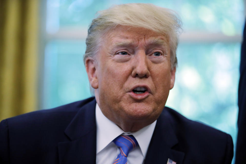 President Donald Trump talks during a signing ceremony in the Oval Office of the White House in Washington, Monday, July 1, 2019, with Vice President Mike Pence, left, and Secretary of Health and Human Services Alex Azar. The president signed a $4.6 billion aid package to help the federal government cope with the surge of Central American immigrants at the U.S.-Mexico border. (AP Photo/Carolyn Kaster)