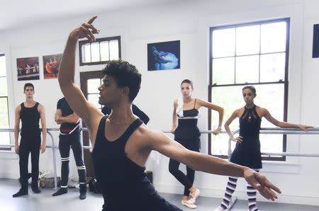 Carlos Ignacio Galindez and half dozen dancers from the National Ballet of Cuba who defected after a performance in Puerto Rico rehearse for an upcoming performance shortly before a news conference in Miami, Florida June 10, 2014. REUTERS/Gaston De Cardenas