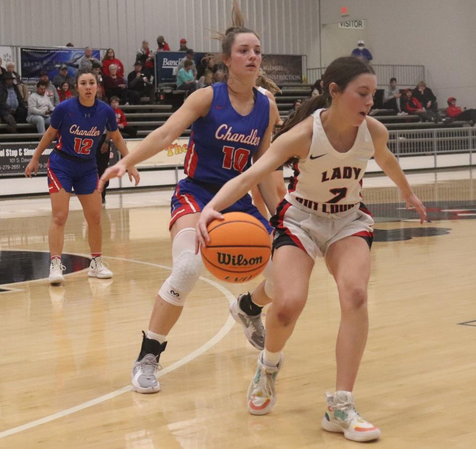 Chandler's Leah Brannon (10) guards Meeker's Tatum Pino as Brannon's teammate Presley Martzall (12) looks on in the background Friday night in the 66 Conference Tournament in Meeker.