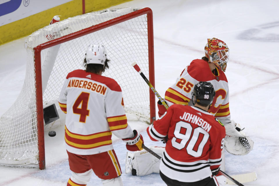 Calgary Flames goalie Jacob Markstrom (25) gives up a goal to Chicago Blackhawks' Seth Jones, not seen, during the first period of an NHL hockey game Tuesday, March 26, 2024, in Chicago. (AP Photo/Paul Beaty)