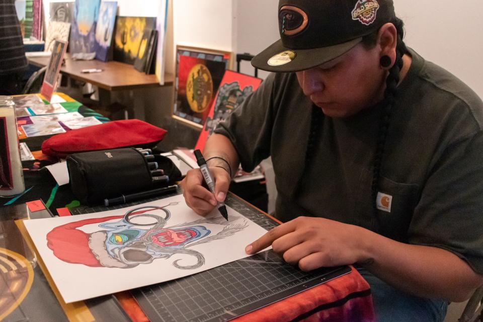 Chadwick Pasqual works on a piece at the new Cahokia art space during First Friday on Dec. 3, 2021, in Phoenix.