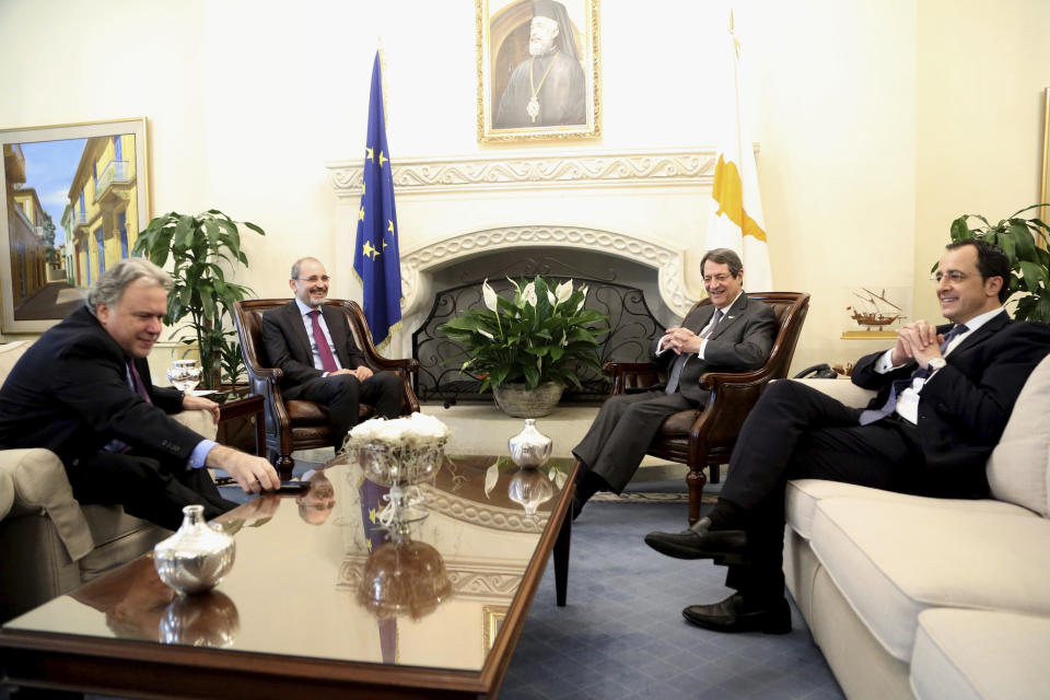 Cyprus' president Nicos Anastasiades, second right, and Cypriot foreign minister Nicos Christodoulides, right, talk with Foreign minister of Jordan Ayman Safadi, second left, and the Greek Alternate Minister of Foreign Affairs Georgios Katrougalos during their meeting at the presidential palace in Nicosia, Cyprus, Wednesday, Dec. 19, 2018. The ministers are meeting in the Cypriot capital to explore ways of strengthening ties on fields as varied as education and entrepreneurship. (AP Photo/Petros Karadjias)